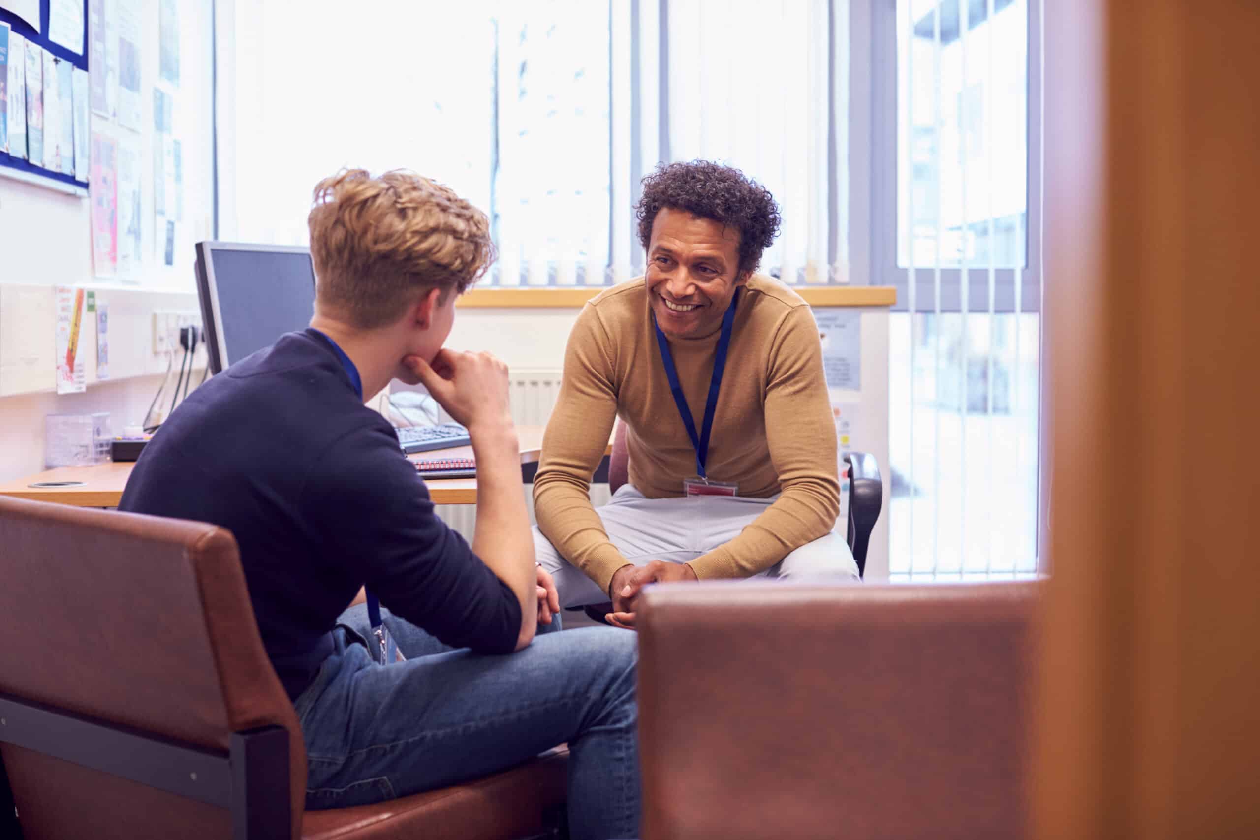 student and teacher discussing mental health